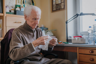 Midsection of man holding table at home