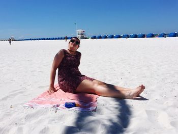 Portrait of woman on beach against sky