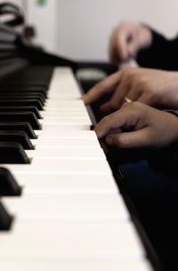 Close-up of hands playing piano
