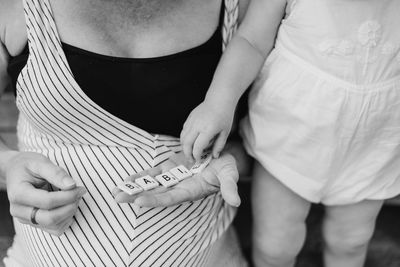 Midsection of couple holding hands