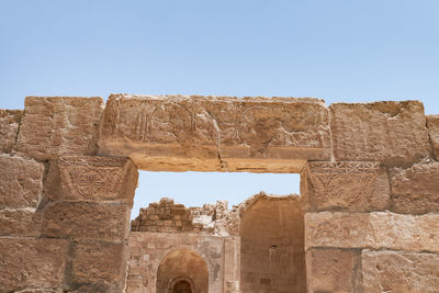 Low angle view of old ruins against clear sky