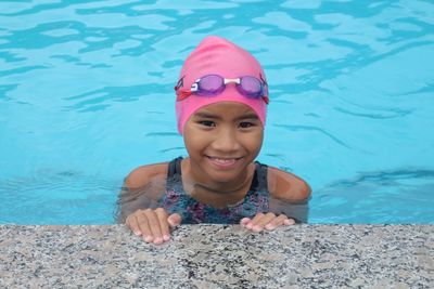 Portrait of smiling girl swimming in pool