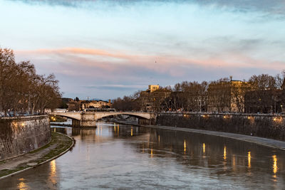 Bridge over river with city in background