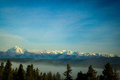 Scenic view of mountains against blue sky