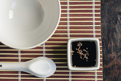 Vessel with soy sauce and sesame on an oriental table setting