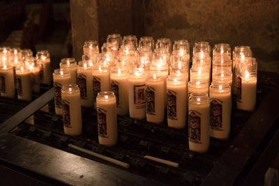 Row of illuminated candles in temple