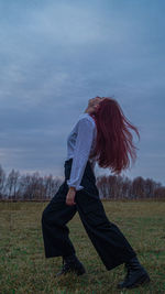 Side view of senior woman standing on field