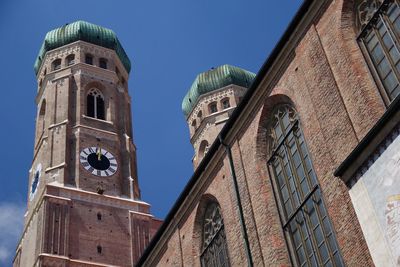 Low angle view of bell tower against blue sky