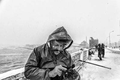 Man holding ice cream against sky