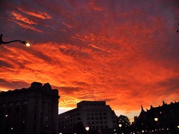 Low angle view of building against cloudy sky at sunset