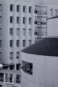 View of round fronted building in foreground with office buildings in background 