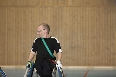 Sportsman in wheelchair in gym