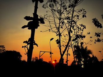 Low angle view of silhouette trees against sky during sunset