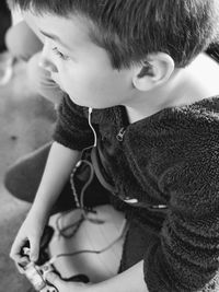 Cute boy playing video game at home