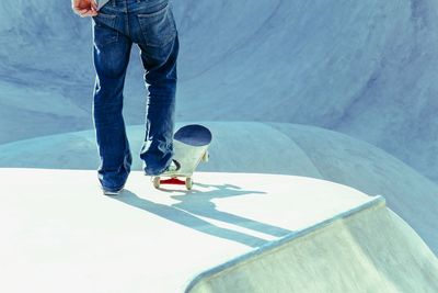 Low section of man skateboarding at skateboard park