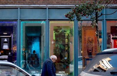 Reflection of man on glass window
