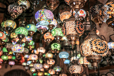 Low angle view of illuminated lanterns hanging on ceiling