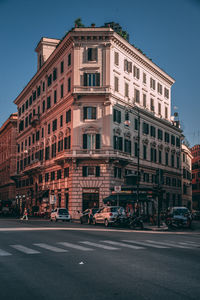 View of city street and buildings against sky