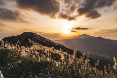 Scenic view of mountains against sky during sunset