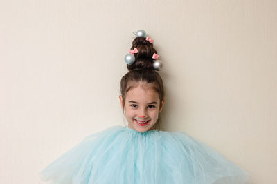 Portrait of funny girl with a hairstyle in the form of a christmas tree