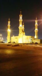 Illuminated building against sky at night