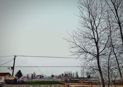 Low angle view of power lines against clear sky