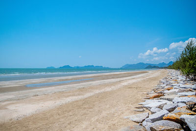 Scenic view of beach against blue sky