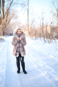 Full length of woman standing in snow