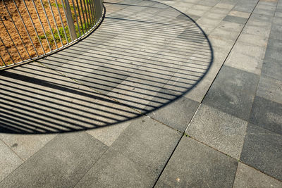 High angle view of shadow on footpath