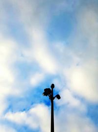 Low angle view of bird perching on street light