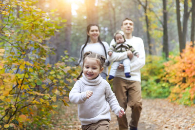 Cheerful family waking at park