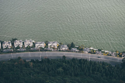 High angle view of buildings by sea