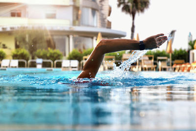 Close-up of person swimming in pool