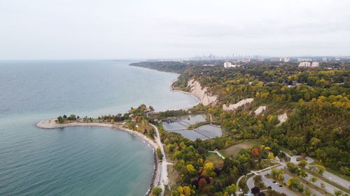 High angle view of cityscape by sea against sky