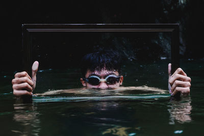 Portrait of man swimming in pool