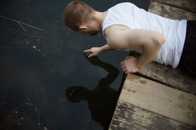 High angle view of man standing on wood