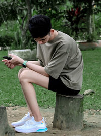 Side view of young woman exercising in park