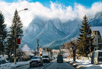 Traffic on mountain town street in a winter sunny day