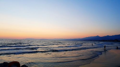 Scenic view of sea against clear sky during sunset