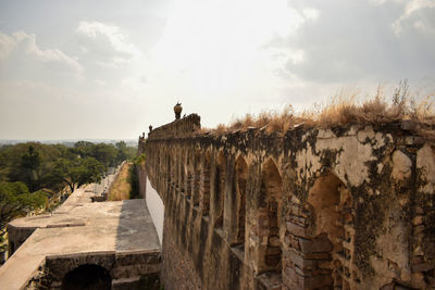 Golconda fort area ruined walls in india background stock photograph