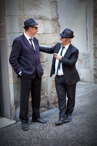 Full length of men standing on wall