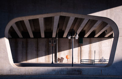 Man on bridge against building in city