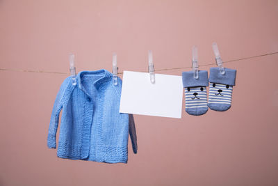 Close-up of clothes drying against white background