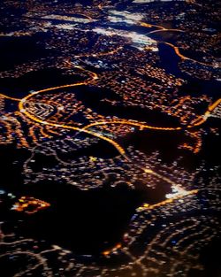 High angle view of illuminated sea against sky at night