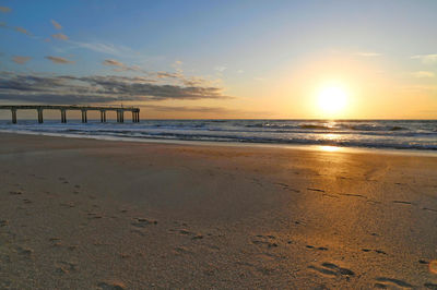 Scenic view of beach against sky during sunset