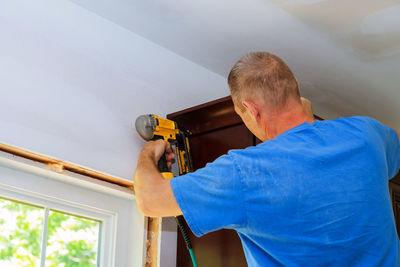 Low angle view of man holding camera