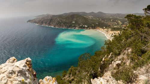 High angle view of sea and mountains against sky