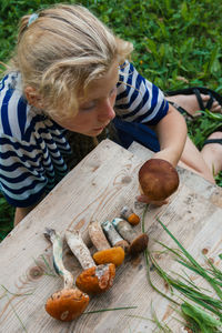 High angle view of girl sitting on table