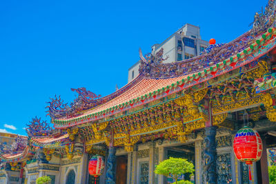 Low angle view of temple against clear blue sky