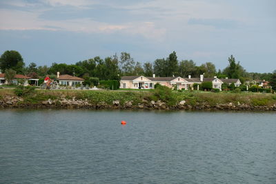 Scenic view of sea by building against sky